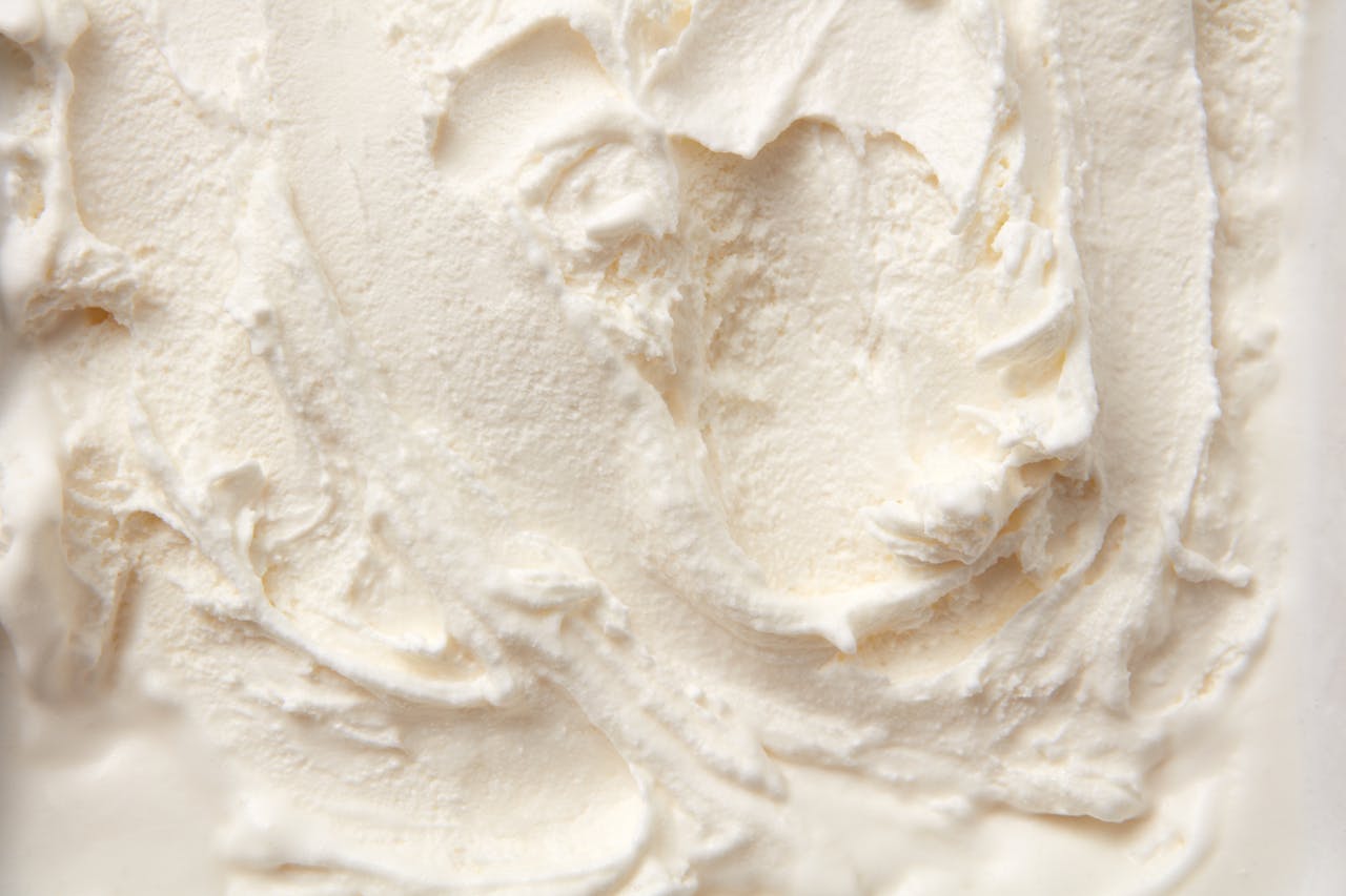 High-resolution close-up of smooth vanilla ice cream texture, perfect for food bloggers and culinary projects.